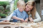 Mother and son baking in kitchen