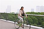 Businesswoman Cycling on Bridge