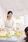 Smiling Woman Serving Food To Her Daughter