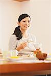 Japanese Woman Eating Food And Smiling