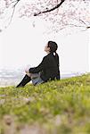 High School Girl Sitting Under Cherry Blossom Tree