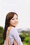 Young Japanese Women Smiling And Carrying Handbag