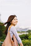 Young Japanese Women Smiling And Carrying Handbag