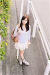 Japanese Women Leaning Against Pole