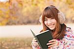 Japanese Women Smiling And Holding Book