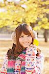 Japanese Women Smiling And Holding Ginkgo Leaf