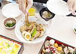 Hands picking up simmered dish