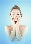 Young woman with hands on cheeks