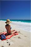 Woman relaxing on Floreat beach, Perth, Western Australia, Australia