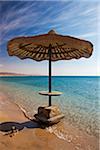 Sun umbrella on the beach at makman el Tiyha, Janub Sina, Gulf of Suez, Red Sea, Sinai Peninsula, Egypt Africa.