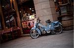 An old scooter parked on a street in Lyon France