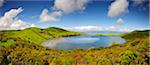 The Lagoa do Caiado crater (Caiado lagoon), one of the undreds of craters spread along the Pico island. On the horizon we can see Sao Jorge island. Azores islands, Portugal