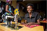 Kigali, Rwanda. A lady makes clothes in Kimironko market.