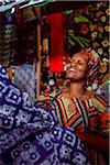 Kigali, Rwanda. A woman sells traditional fabric in Kimironko market.