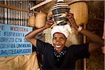 Kigali, Rwanda. A member of a weaving cooperative displays traditional baskets.