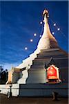 Thailand, Mae Hong Son, Mae Hong Son.  Chedi at Wat Phra That Doi Kong Mu illuminated at night.