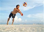 Man Playing Volleyball on Beach, Mexico