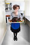 Woman Holding Burnt Turkey on Platter