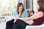 Two Women Drinking Wine on Porch