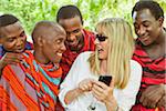 Woman Showing Cell Phone to Group of Masai Men