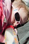 Baby girl lying down, drinking milk from bottle