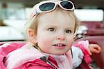 Toddler girl with sunglasses on her head, portrait