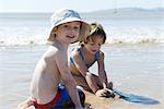 Boy playing with sister at the beach