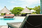 Lounge chair beside pool at resort