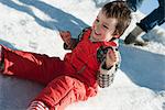Boy sitting in snow, smiling