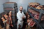 Butcher in meat storage area