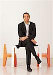 Businessman sitting on a miniature table, Sweden.