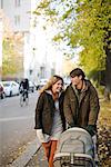 A couple taking a walk with their baby, Sweden.