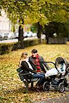 A couple siting with their son in a park, Sweden.