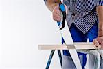 A joiner using a saw.