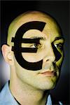 A euro sign projected on a man's face.