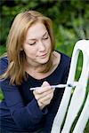 Woman painting chair