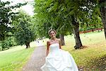 Bride running in park