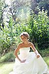 Bride sitting in park