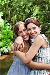 Mother and daughter hugging in forest