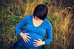 Pregnant woman touching stomach