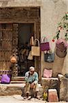 Basket Seller Using Cell Phone, Stone Town, Unguja, Zanzibar, Tanzania