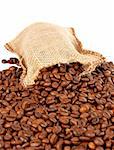 Burlap sack with coffee beans spilling out over a white background