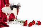 two glasses of champagne with white and black bow knots, carnation and red velvet on white background with copyspace.