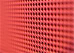 Futuristic red hole grid making an abstract pattern. Shallow DOF.