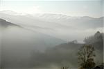 Fog in a landscape of mountains during the winter