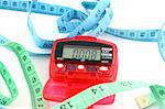 Close up of a Pedometer and 2 tape measures - isolated on a white background