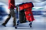 Man with red bags at the airport, motion blur