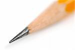 Tip of a sharp pencil on white background, shallow dof