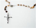 Rosary beads close up isolated on white
