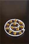 Green and Black olives in a sprial bowl
